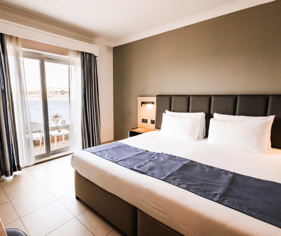 Contemporary hotel bedroom furniture at Qawra Palace Resort & Spa with guest room and balcony view
